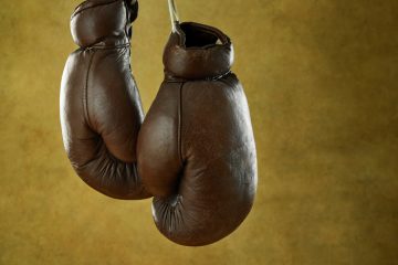 Old,Leather,Boxing,Gloves,On,A,Wall